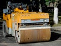 Yellow Asphalt Compactor or Road roller is ready to works for territory improvement.