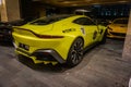 Yellow Aston Martin Vantage in a hotel parking lot Royalty Free Stock Photo