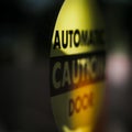 Close view of Automatic Door Caution Sign
