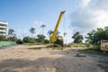 Yellow automobile crane with risen telescopic boom outdoors. Mobile construction crane on a constructin site. Crane Royalty Free Stock Photo