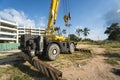 Yellow automobile crane with risen telescopic boom outdoors. Mobile construction crane on a constructin site. Crane Royalty Free Stock Photo