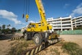 Yellow automobile crane with risen telescopic boom outdoors. Mobile construction crane on a constructin site. Crane Royalty Free Stock Photo