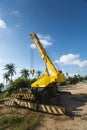 Yellow automobile crane with risen telescopic boom outdoors. Mobile construction crane on a constructin site. Crane Royalty Free Stock Photo