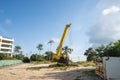 Yellow automobile crane with risen telescopic boom outdoors. Mobile construction crane on a constructin site. Crane Royalty Free Stock Photo