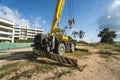 Yellow automobile crane with risen telescopic boom outdoors. Mobile construction crane on a constructin site. Crane Royalty Free Stock Photo