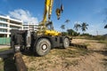 Yellow automobile crane with risen telescopic boom outdoors. Mobile construction crane on a constructin site. Crane Royalty Free Stock Photo