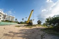 Yellow automobile crane with risen telescopic boom outdoors. Mobile construction crane on a constructin site. Crane Royalty Free Stock Photo