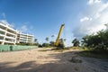 Yellow automobile crane with risen telescopic boom outdoors. Mobile construction crane on a constructin site. Crane Royalty Free Stock Photo