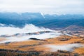 Yellow autumn trees on the hills with clouds at sunrise. Kurai steppe in Altai, Russia Royalty Free Stock Photo