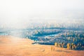 Yellow autumn trees and river in morning fog at sunrise. Chuya river in Kurai steppe, Altai, Russia Royalty Free Stock Photo