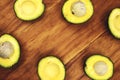 Yellow avocado half on rustic wooden board. Avocado top view photo banner with text place. Cut avocado vegetable Royalty Free Stock Photo