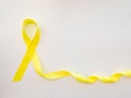 Yellow awareness ribbon on light background, Yellow ribbon symbolic color for Sarcoma Bone cancer, Spina Bifida Awareness Month Royalty Free Stock Photo