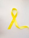 Yellow awareness ribbon on light background, Yellow ribbon symbolic color for Sarcoma Bone cancer, Spina Bifida Awareness Month Royalty Free Stock Photo