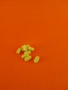 yellow B vitamins strewn with an orange background Royalty Free Stock Photo