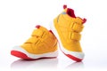 Yellow baby shoes. Kids sport sneakers isolated on white background Royalty Free Stock Photo