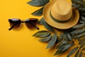 Yellow background adorned with tropical leaves hats glasses and eyeshadow, summer season nature image