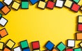 Yellow background with colorful squares as a frame with copy space. Colored frame. Educational and smart toys, puzzle Royalty Free Stock Photo