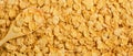 Yellow background of corn flakes. Wooden spoon. Healthy and nutritious Breakfast. Copy space