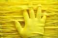 Yellow background and palm in yellow cloth glove