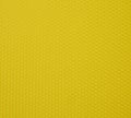 A yellow background texture made up of small hexagons that are slightly convex