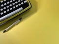 A typewriter is ready to work with a pen next to it Royalty Free Stock Photo