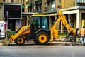 Yellow backhoe loader on construction site ready for working in Bucharest, Romania, 2020