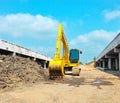 A yellow backhoe is parking