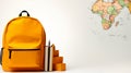 Yellow backpack, stack of books, notebooks isolated on white background with world map, back to school, promo banner, copy space Royalty Free Stock Photo