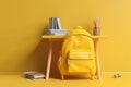 Yellow backpack on a yellow table next to a bookshelf and a stack of books. AI generation