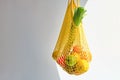 Yellow bag of mixed fruit and vegetables on white background