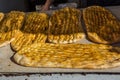 Yellow baked Barbari bread,one of the thickest flat breads, on the food stall in Shirazi, Iran