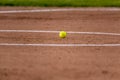 Yellow ball on the clay infield Royalty Free Stock Photo