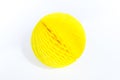 Yellow ball of paper honeycomb. White background. Paper craft