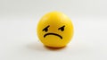 Yellow ball with a sad face on a white background, isolated Royalty Free Stock Photo