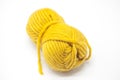 Yellow ball of wool yarn for knitting close up on a white background.