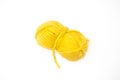 Yellow ball of wool yarn for knitting close up on a white background.