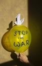 Yellow balloon with blue inscription stop war and paper dove of peace