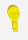 Yellow balloon deflated on a white isolated background Royalty Free Stock Photo