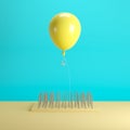 Yellow balloon floating above nail traps on blue pastel background color Royalty Free Stock Photo