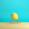 Yellow balloon floating above nail traps on blue pastel background Royalty Free Stock Photo