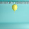 Yellow balloon floating near nail traps on ceiling on blue pastel background Royalty Free Stock Photo