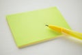 Yellow ballpoint pen and green notes close-up on white paper Royalty Free Stock Photo