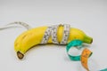 Yellow banana and Measuring tape wrapped around on white background Royalty Free Stock Photo