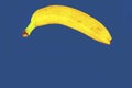 Yellow banana shape on classic blue background. Banana Minimal. Pastel colors style. Popart. Digitalart. Surreal. Pop