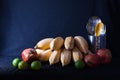 Yellow bananas, green lemons and red pomegranates with cutlery