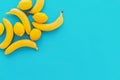 Yellow bananas with lemons on blue paper trendy background, flat Royalty Free Stock Photo