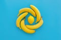Yellow bananas and lemons in circle on bright blue paper, trendy Royalty Free Stock Photo