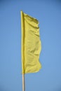 Yellow banner cloth with bamboo pole placed in beach