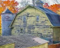 Yellow Barn in Fall with Orange Leaves