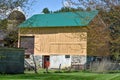 Yellow Barn with Red Door and Green Roof